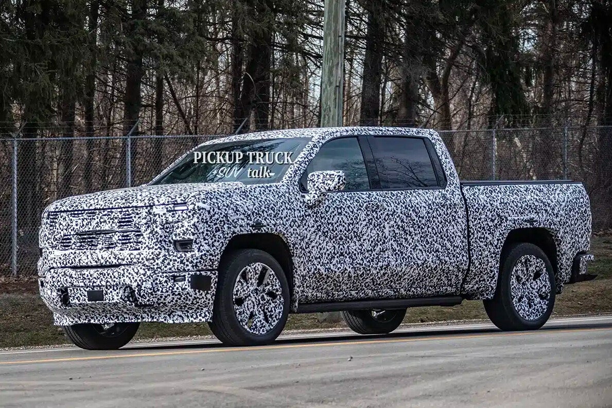 2027 GMC Sierra prototype side view in camouflage