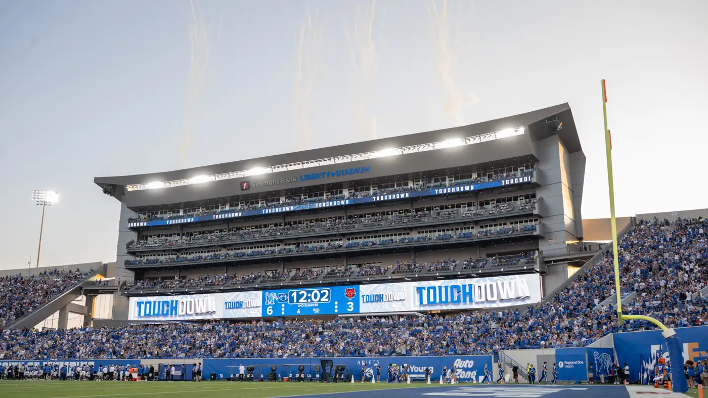 Simmons Bank Liberty Stadium at dusk with a full crowd during a Memphis Tigers football game