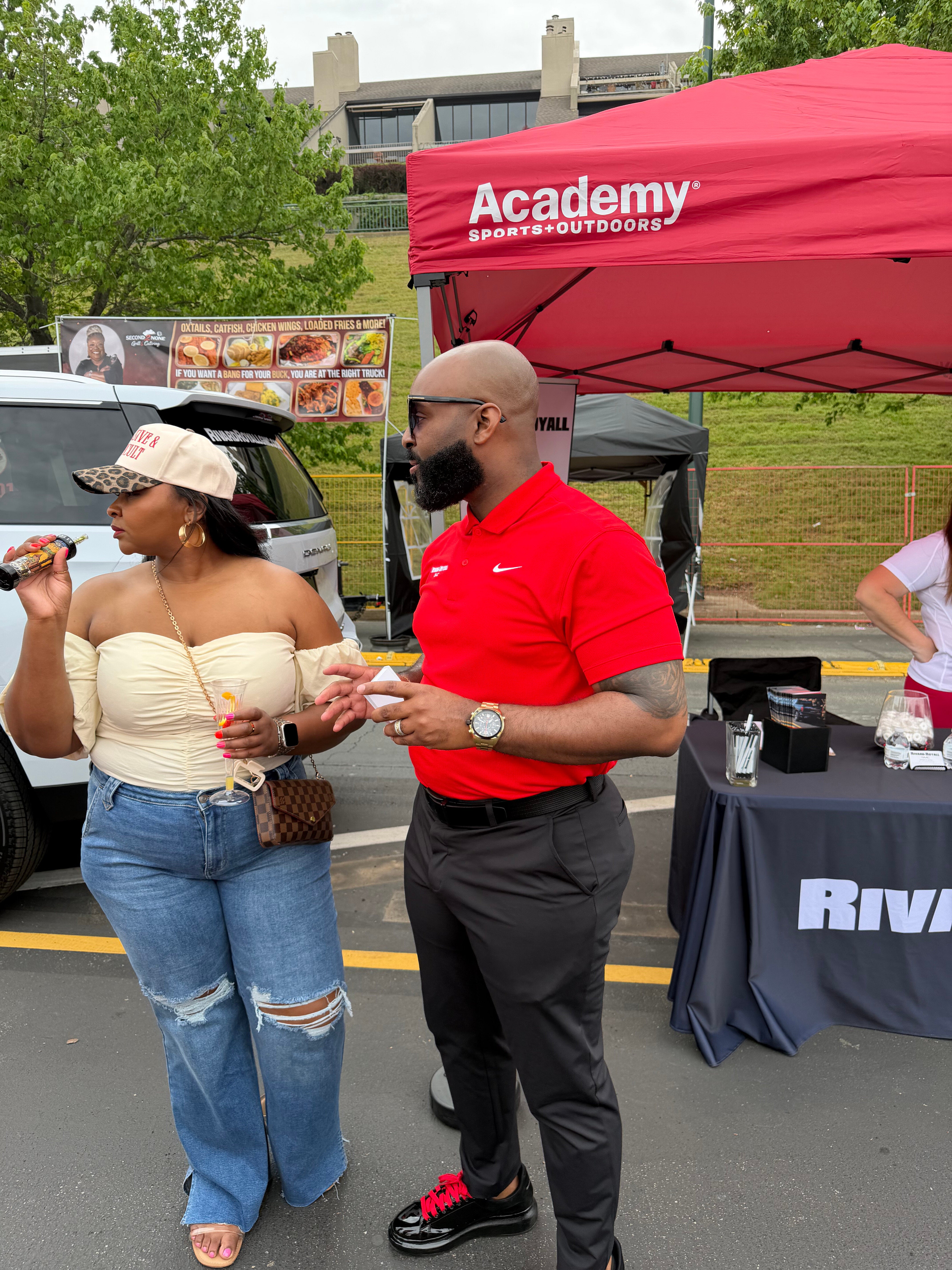 Rivard-Royall GMC team handing out roses to attendees at the Mimosa Festival