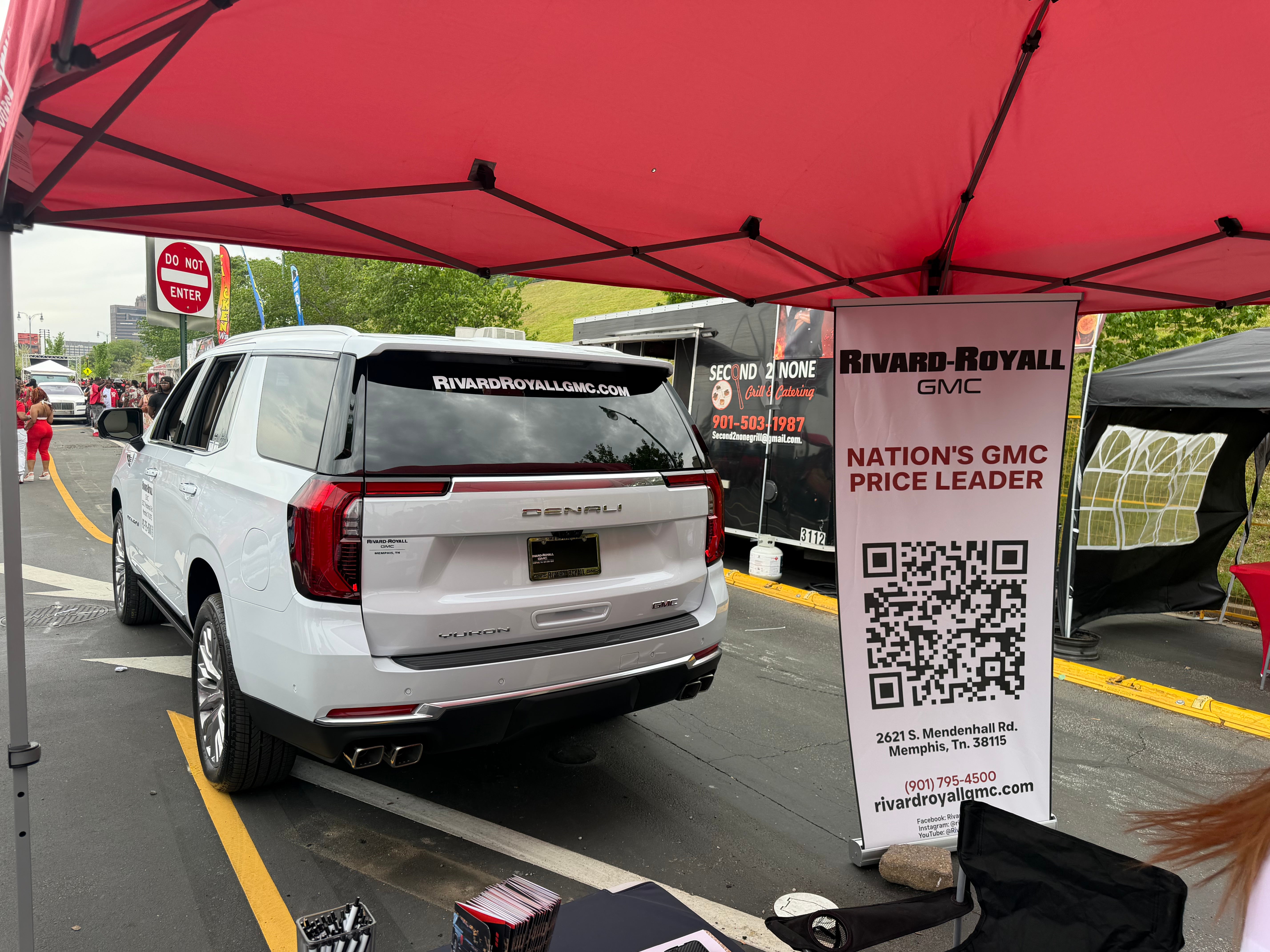 GMC vehicle with Nation's GMC Price Leader banner at the Mimosa Festival