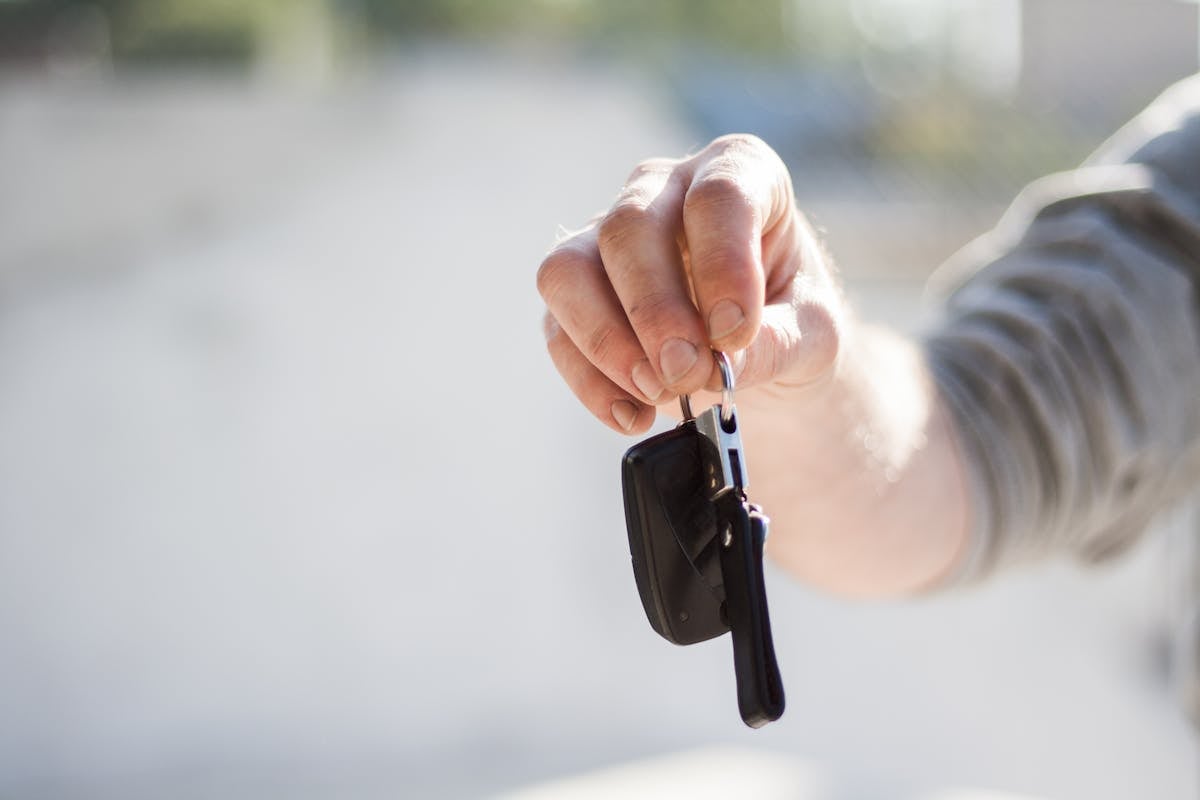 Person handing over car keys - sell your car in Memphis TN